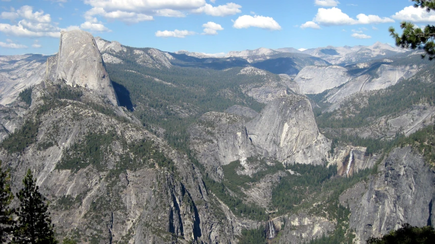 mountains are seen in the distance with lots of trees