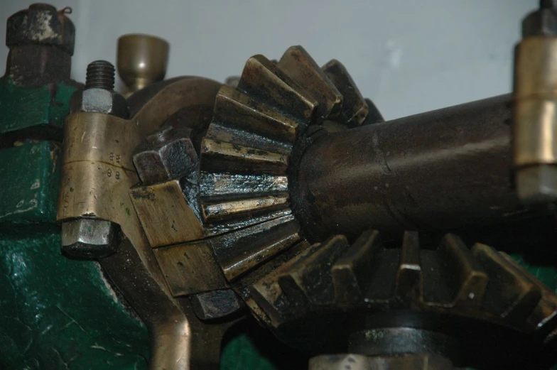 an odd metal object with a large gear that has been cut out