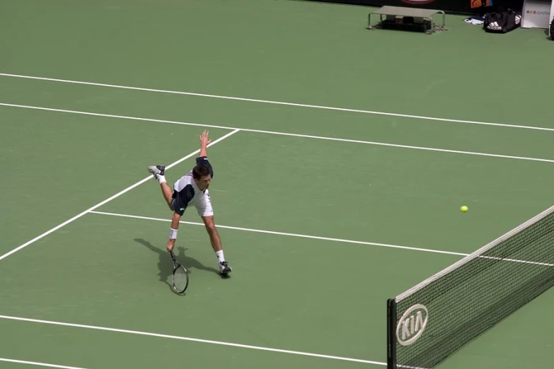 a man with a racket in his hand on a tennis court