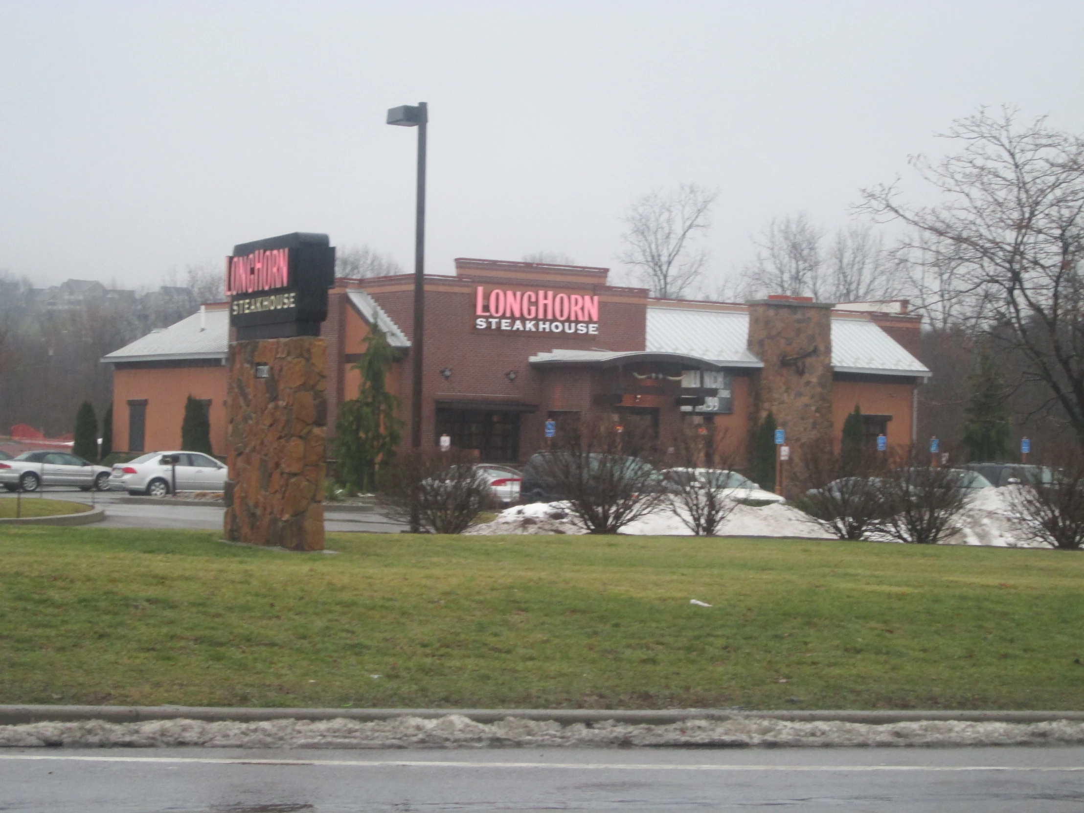 an image of a retail store with cars parked outside