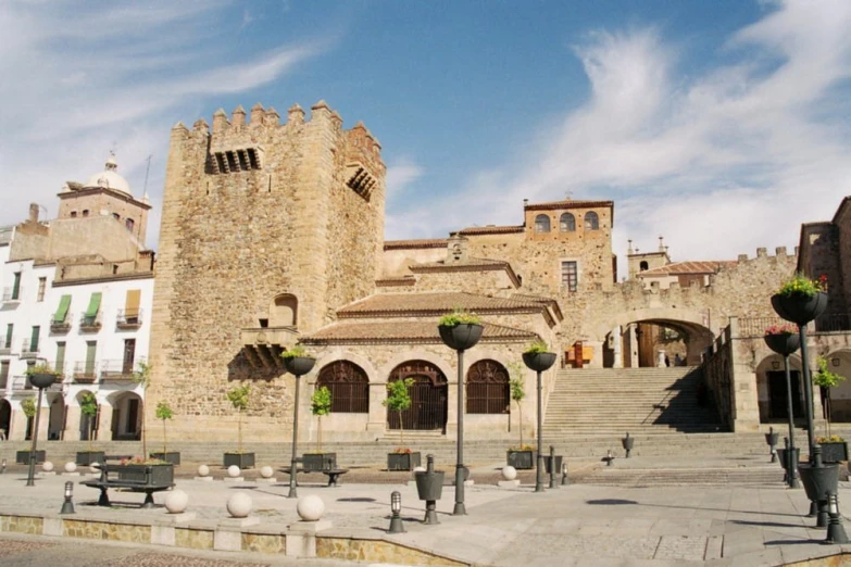 an old castle with benches in front of it