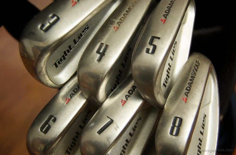 a close up view of many different types of golf clubs