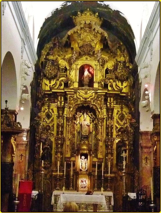 an alter in a church with gold paint and decorations