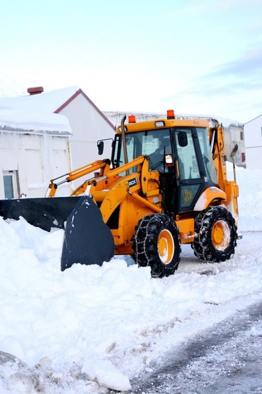 the snow plow is moving through deep snow