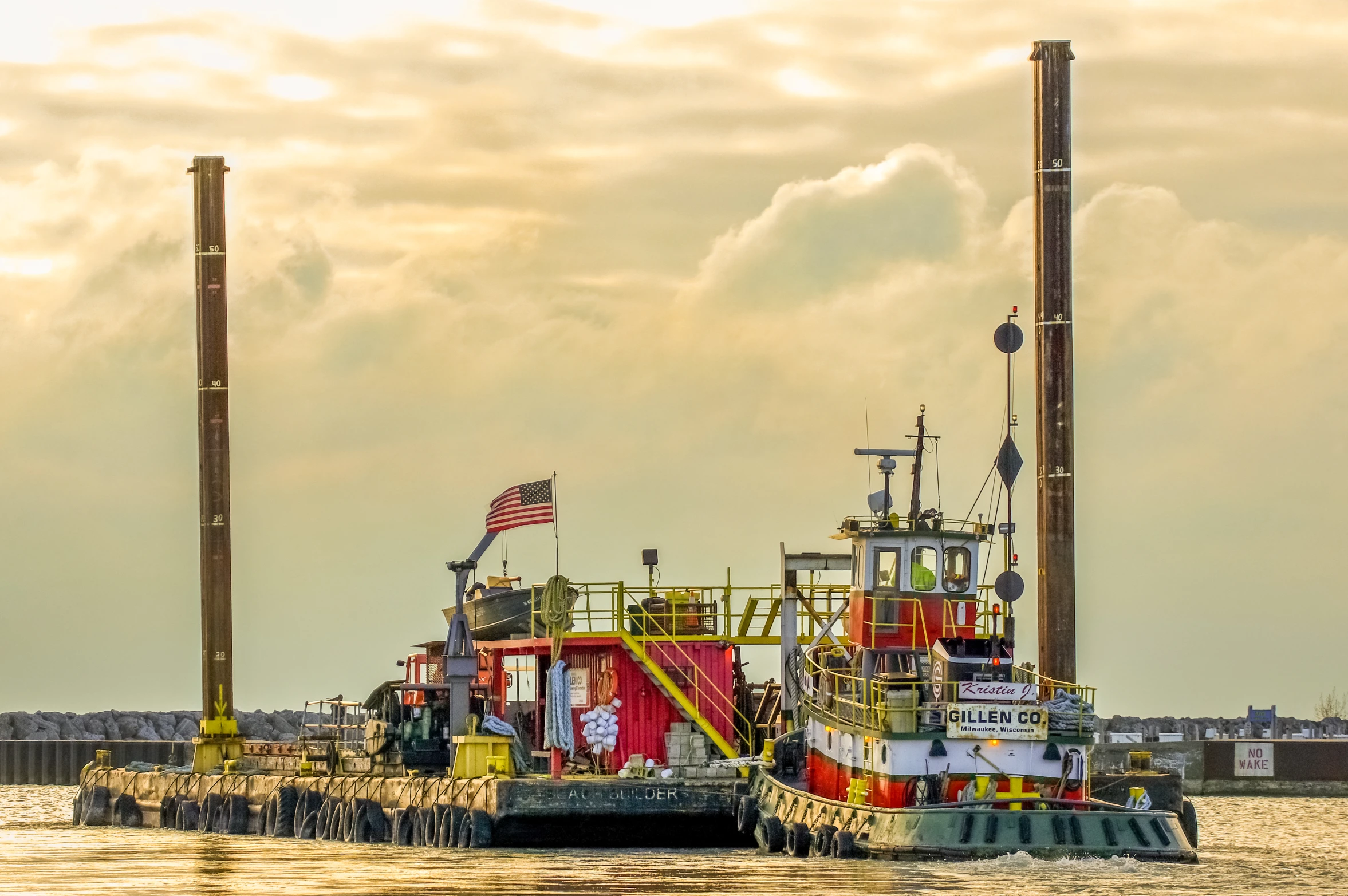 a red and yellow tug boat in the water