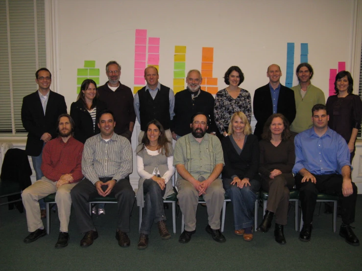 a group of people sitting and standing in a room