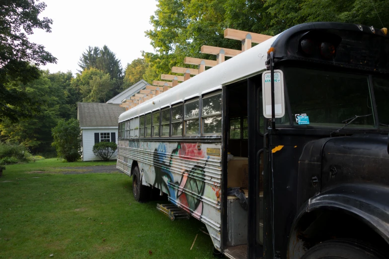 the back of an abandoned bus covered in graffiti