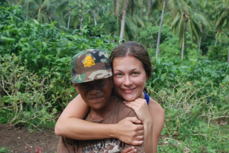 woman emcing a man with trees in the background