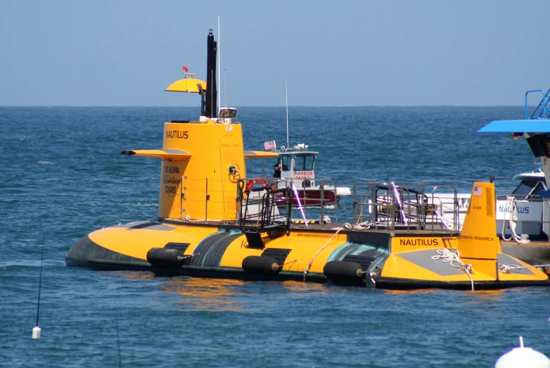 a yellow sub boat in the middle of a body of water