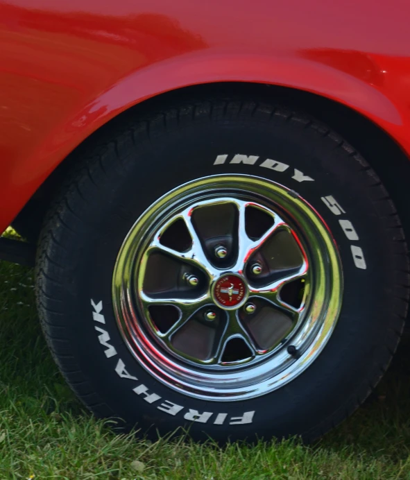 the rims and tires of a red sports car