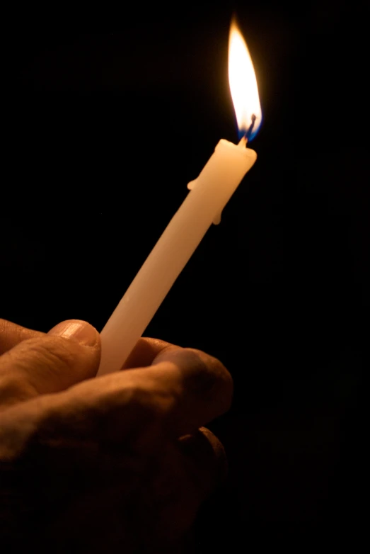 a person holding a candle in their hands