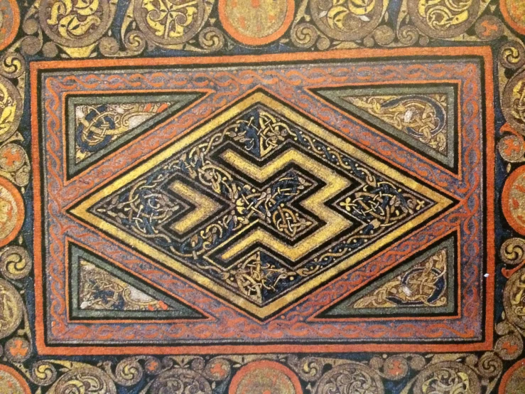 an intricately decorated tile in the ceiling