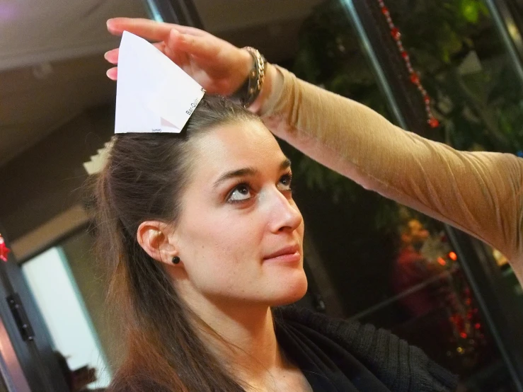 a woman getting her hair styled by an adult