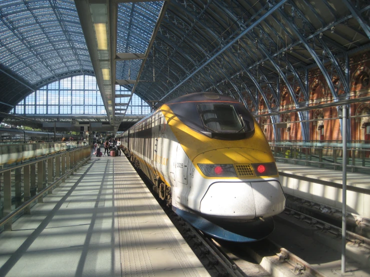 a passenger train is passing by at the station