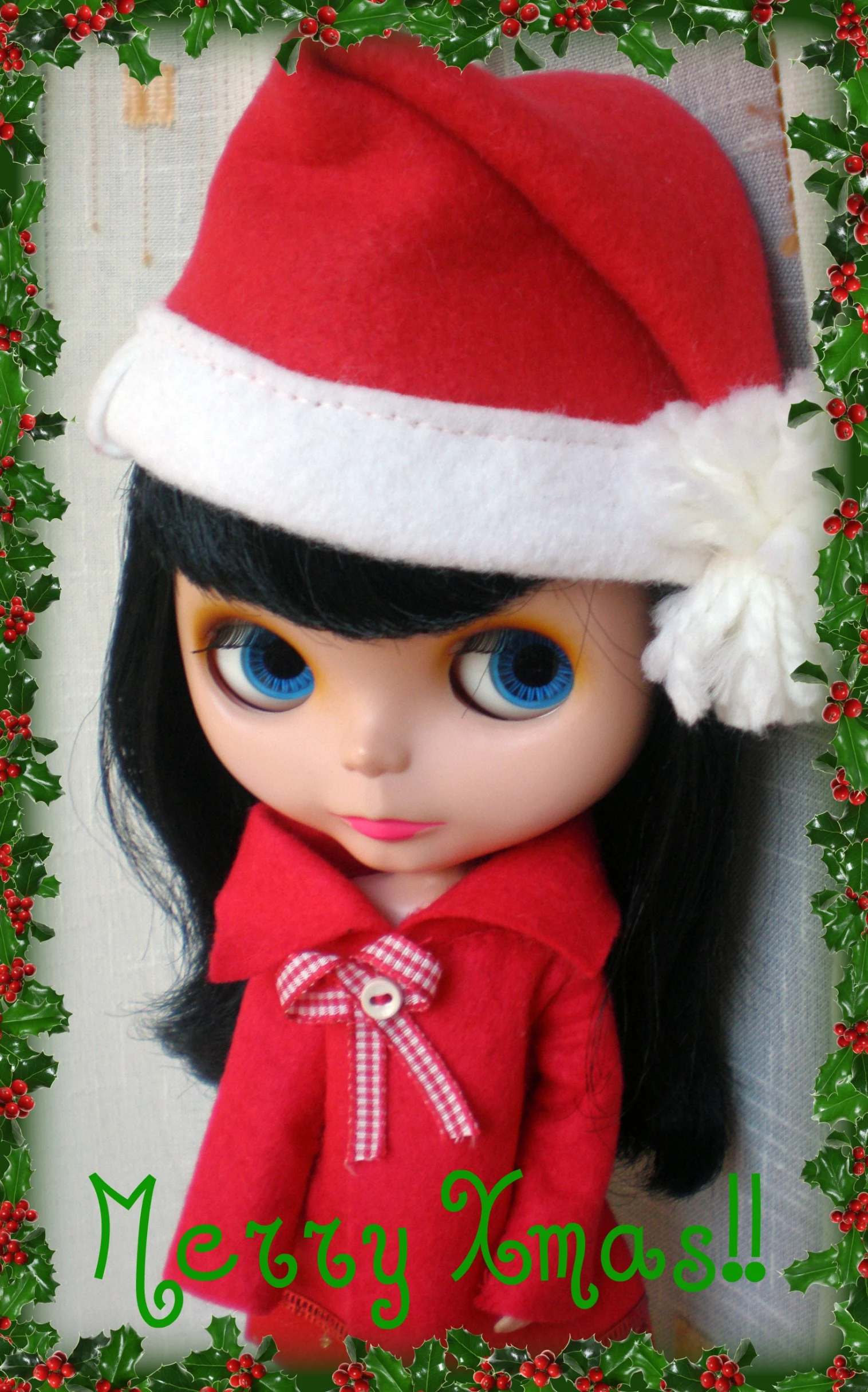 a very cute doll with big blue eyes wearing a santa hat