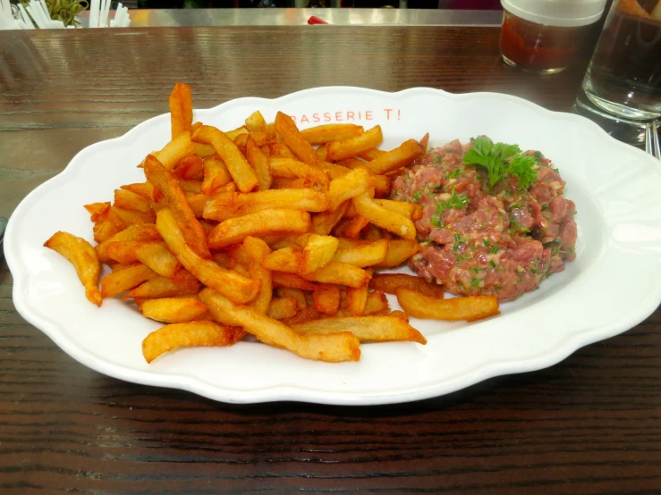 this is some fries on a plate on a table