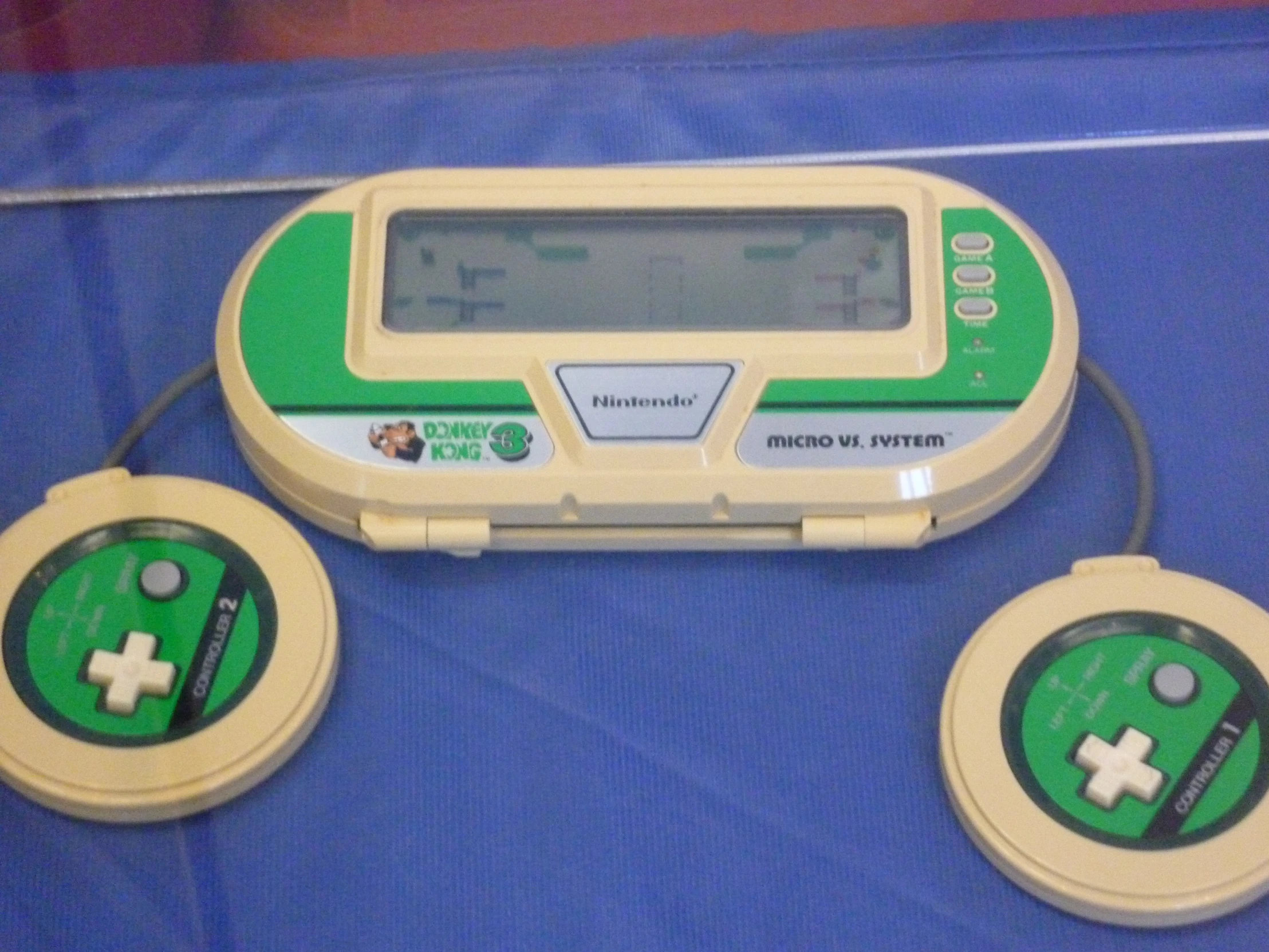 a portable game controller and two discs