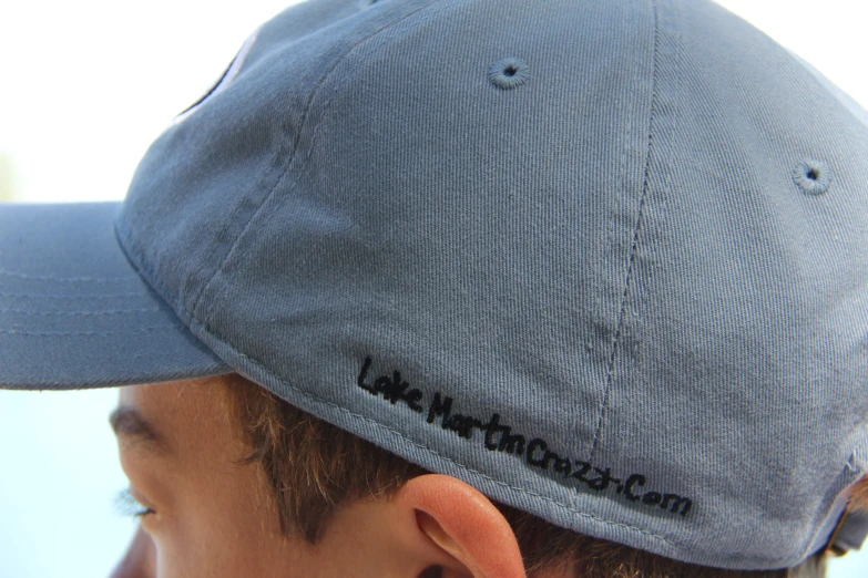 a close up of a person wearing a blue hat
