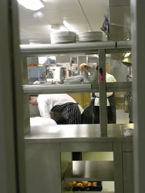 a kitchen area with a cook, cabinets and chefs