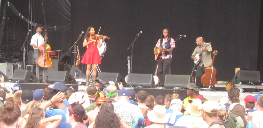 the three musicians are playing with their instruments on stage