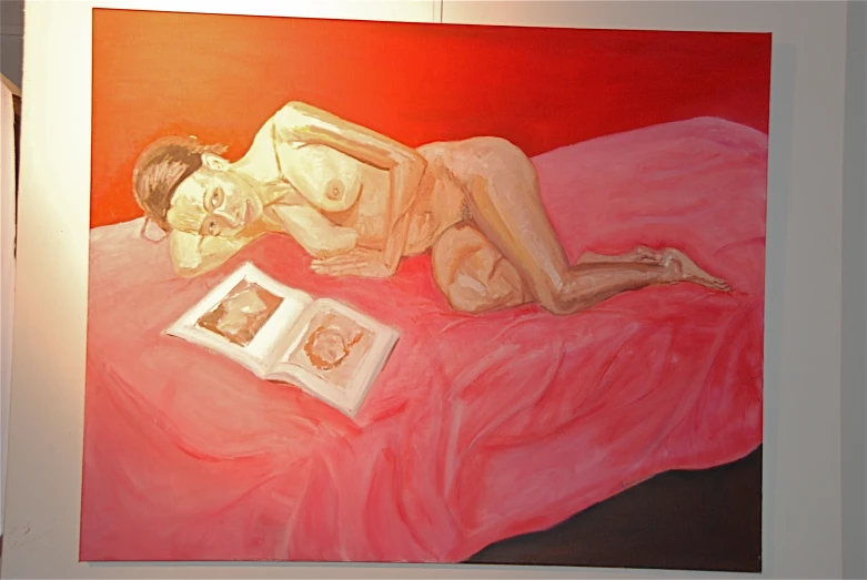 an art piece with a painting of a woman lying on a bed with book