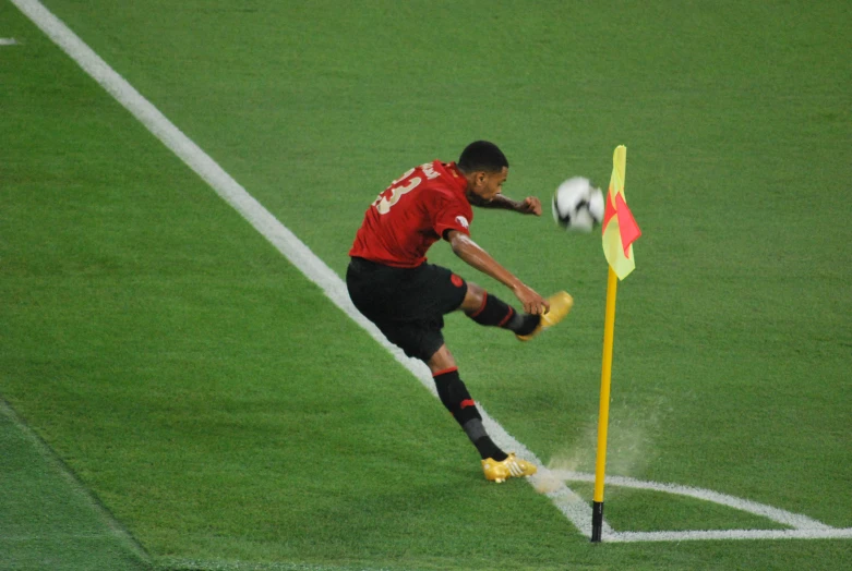 a soccer player jumps into the air to kick the ball