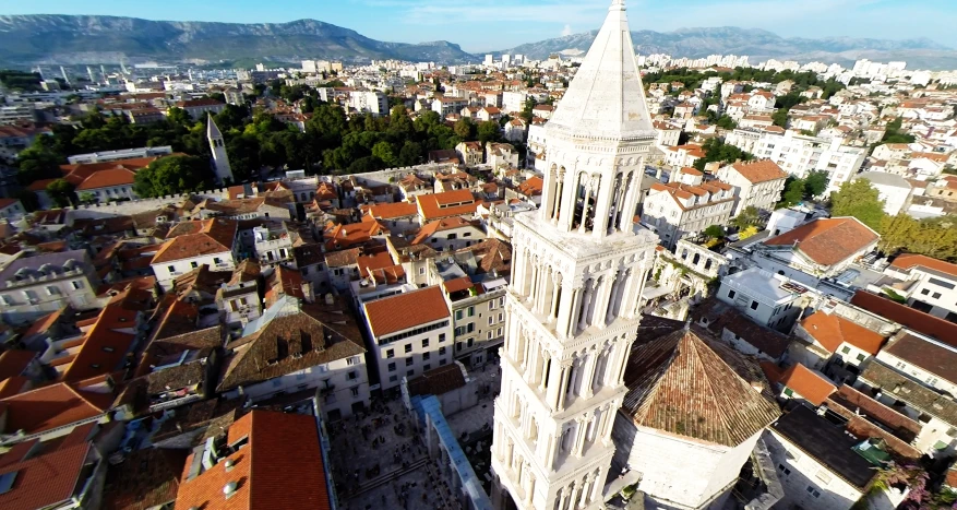 a tall cathedral is standing out from the surrounding city