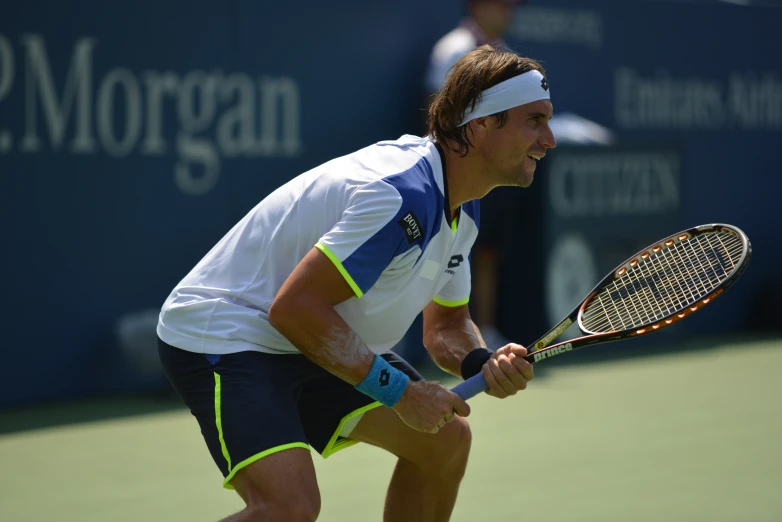 a male tennis player in a white shirt is playing