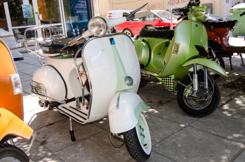 a few vespas parked next to each other on a street