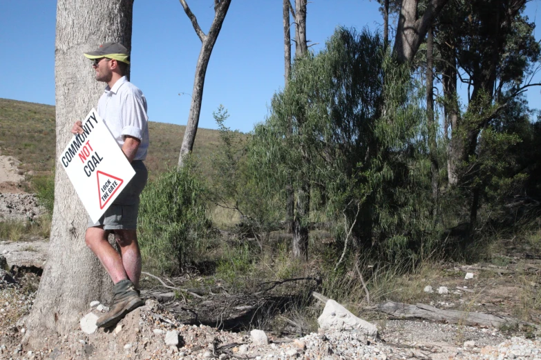 a man is posing for a po on the hillside with his board