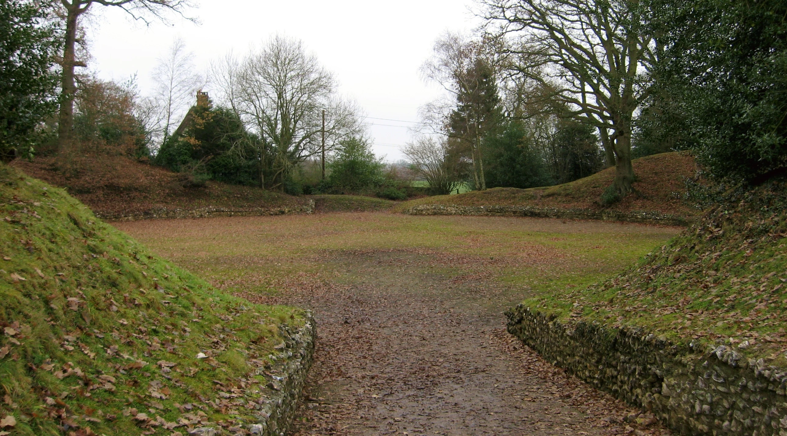 the pathway has two small stones built in the grass on both sides