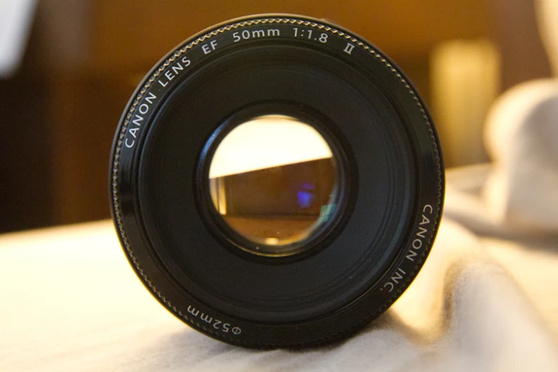 camera lens looking through a hole on a table