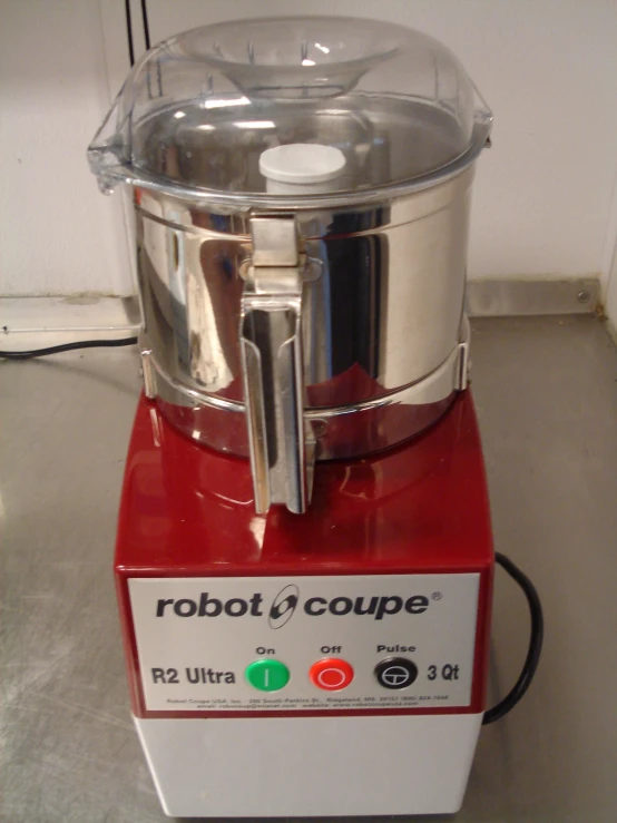 a blender with a metal bowl sitting on the floor