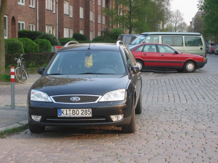 an image of two cars parked on the side of the road