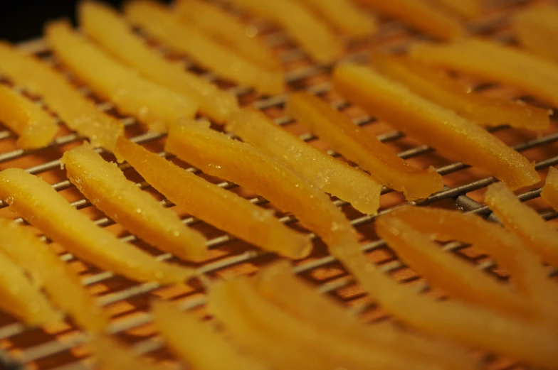 some frying fries sitting on top of a grill