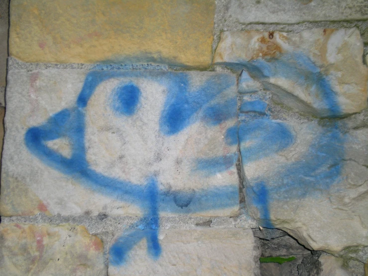 graffiti on a stone wall shows a face