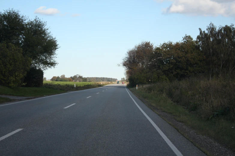 a view of the back of an empty road in the country