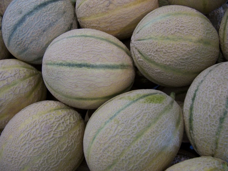 watermelons are stacked up in a pile and ready to be eaten