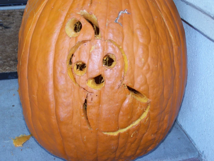 a carved pumpkin with an angry face for the grin