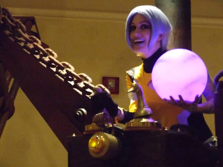 a women in yellow and black costume with light up arms