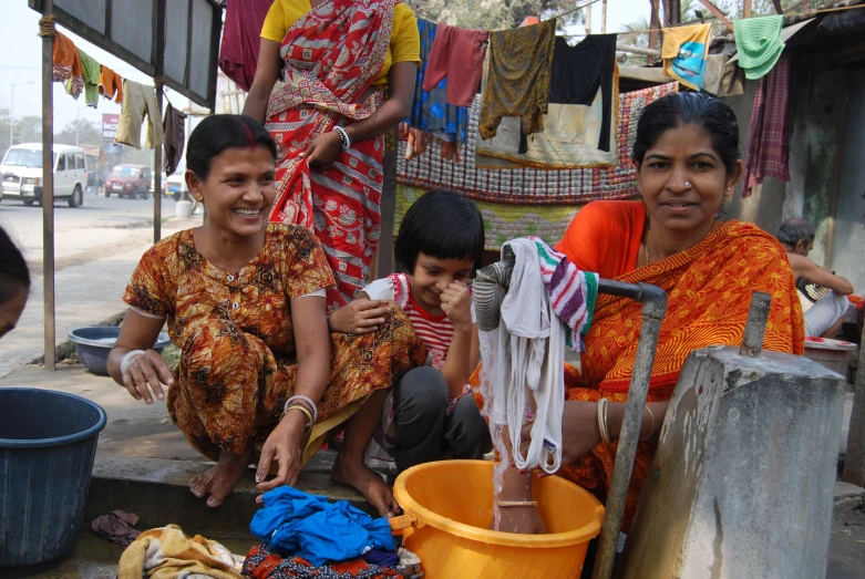 two women standing next to a boy in front of a store