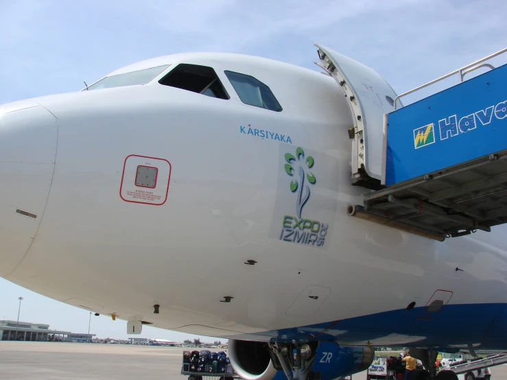 a large air plane with a man loading soing on the side of it