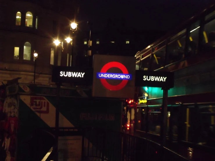 a red double decker bus and street sign