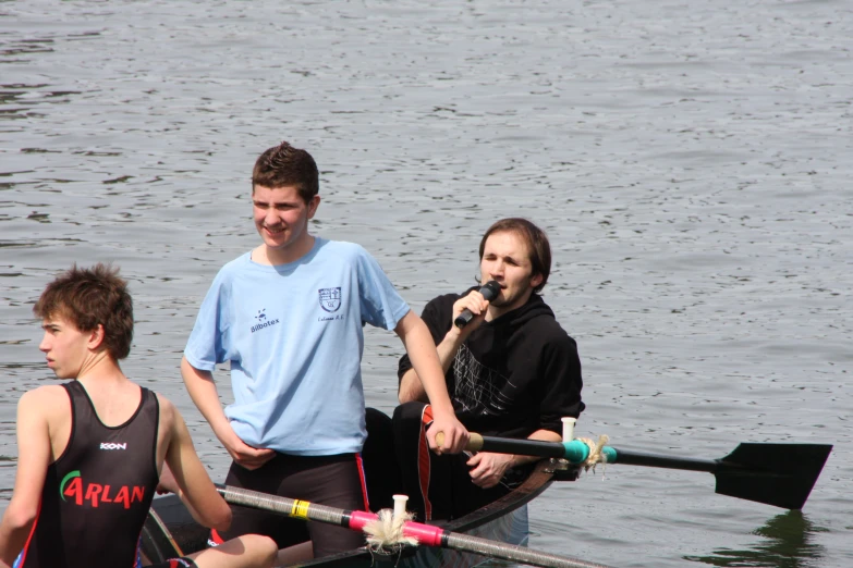 there are three people rowing a small boat