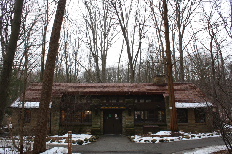 the front entrance to a home surrounded by trees