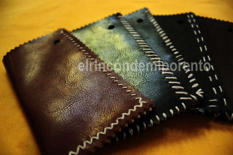 a couple of small brown and black leather pieces