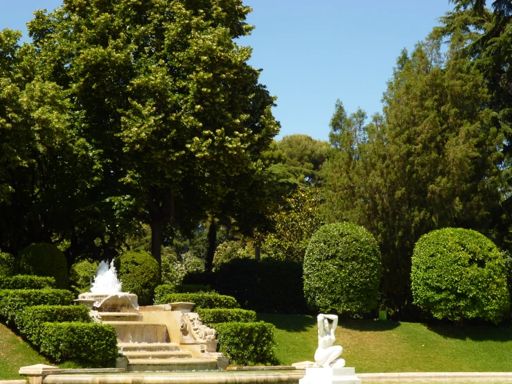 three sculptures sit on display in a park