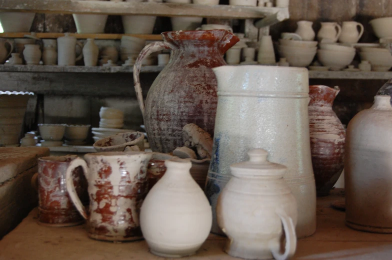 various jars in a row on top of a table