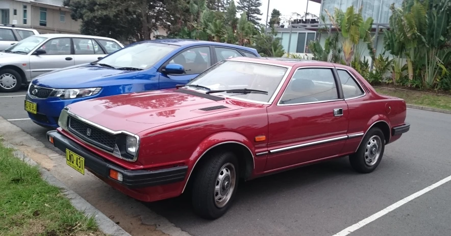 two colorful cars are parked side by side