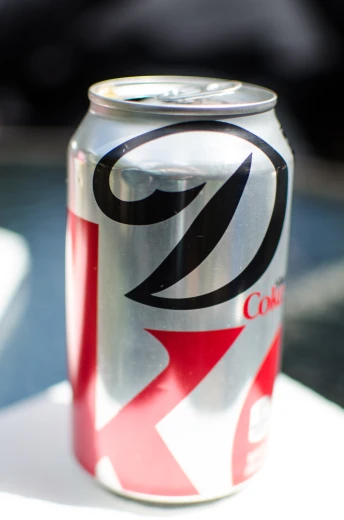 an aluminum can with a red arrow painted on it